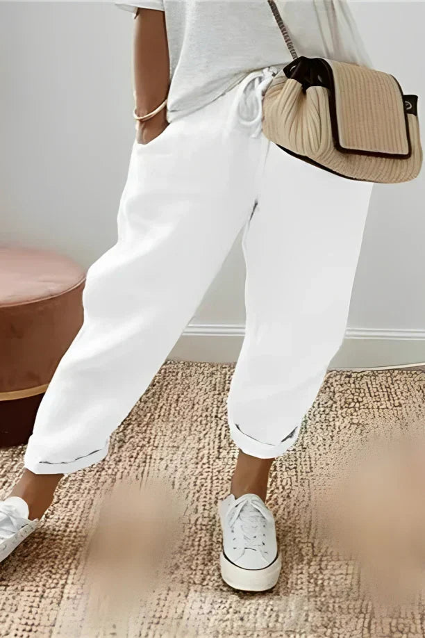 Plain-colored trousers with drawstring and slanted pocket